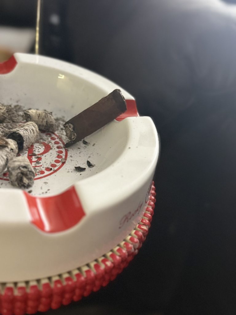 Nearly finished Alec Bradley Black Market Toro nub in an ashtray surrounded by ash