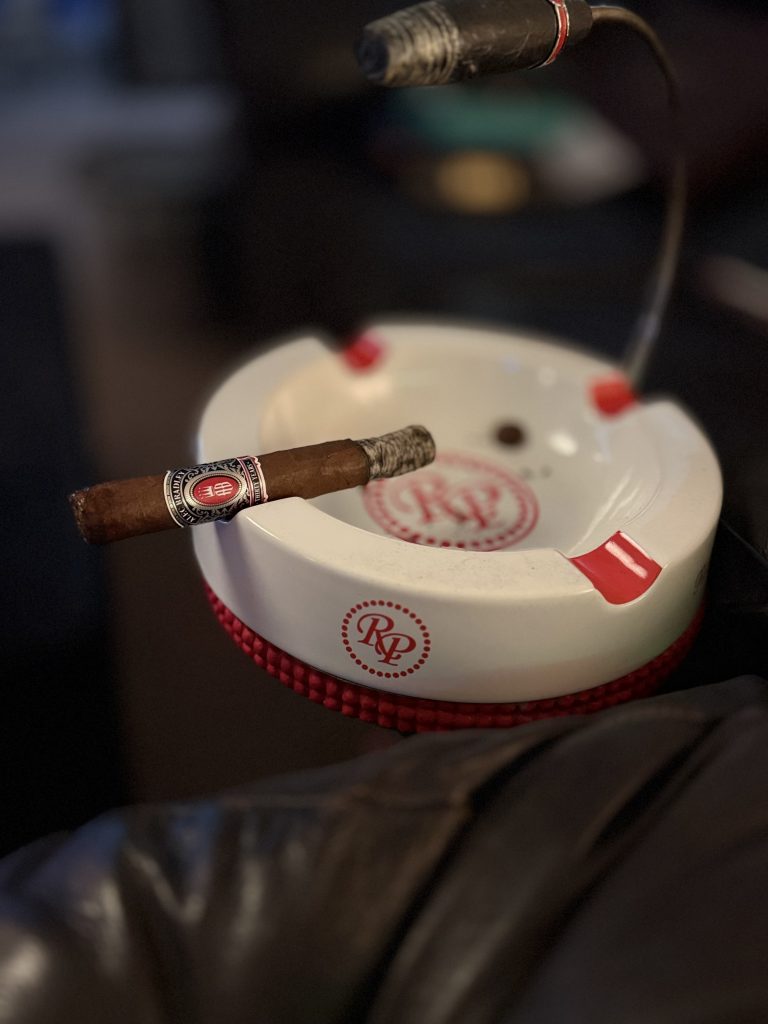 The Alec Bradley Thirty Year Toro burns evenly while resting across a white Rocky Patel ashtray during the middle of the smoking session.