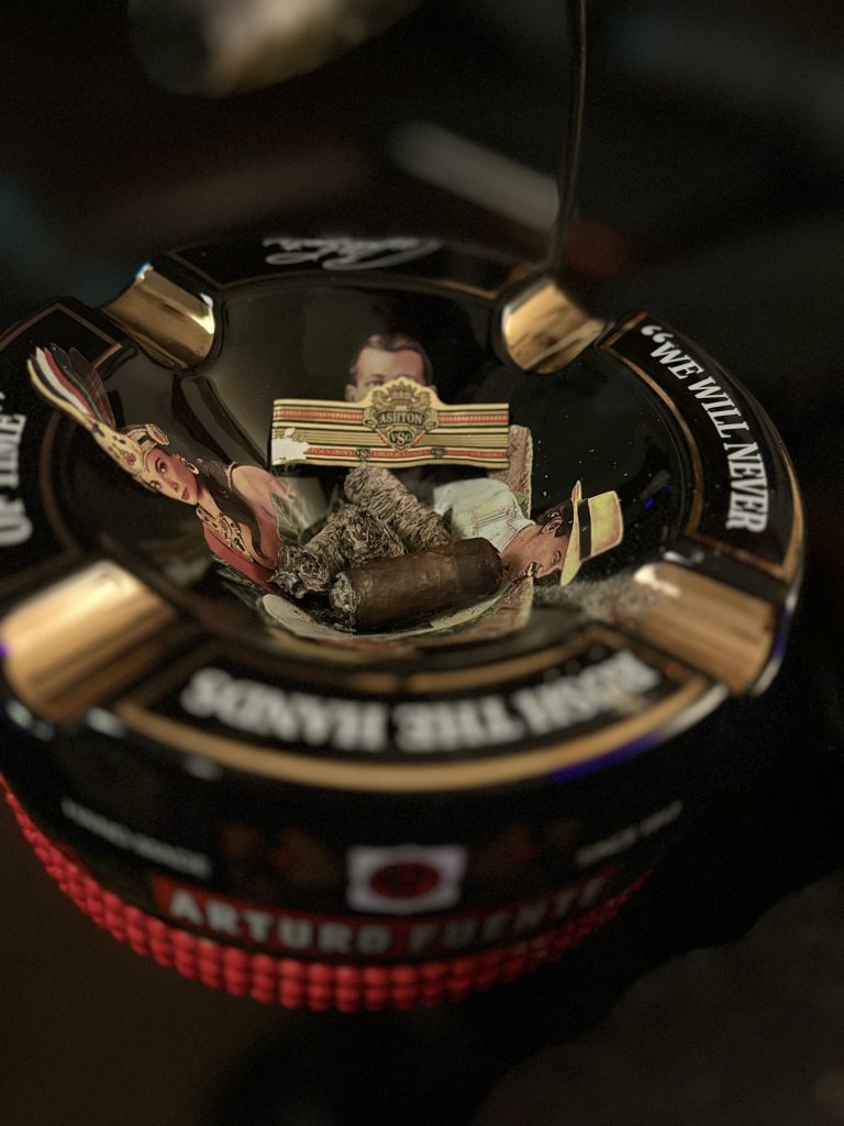 Ashton VSG Sorcerer nub, cigar ash and removed VSG band inside an Arturo Fuente ashtray.