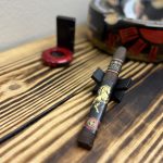 Rocky Patel 2026 Year of the Horse Churchill resting on a black cigar stand before lighting