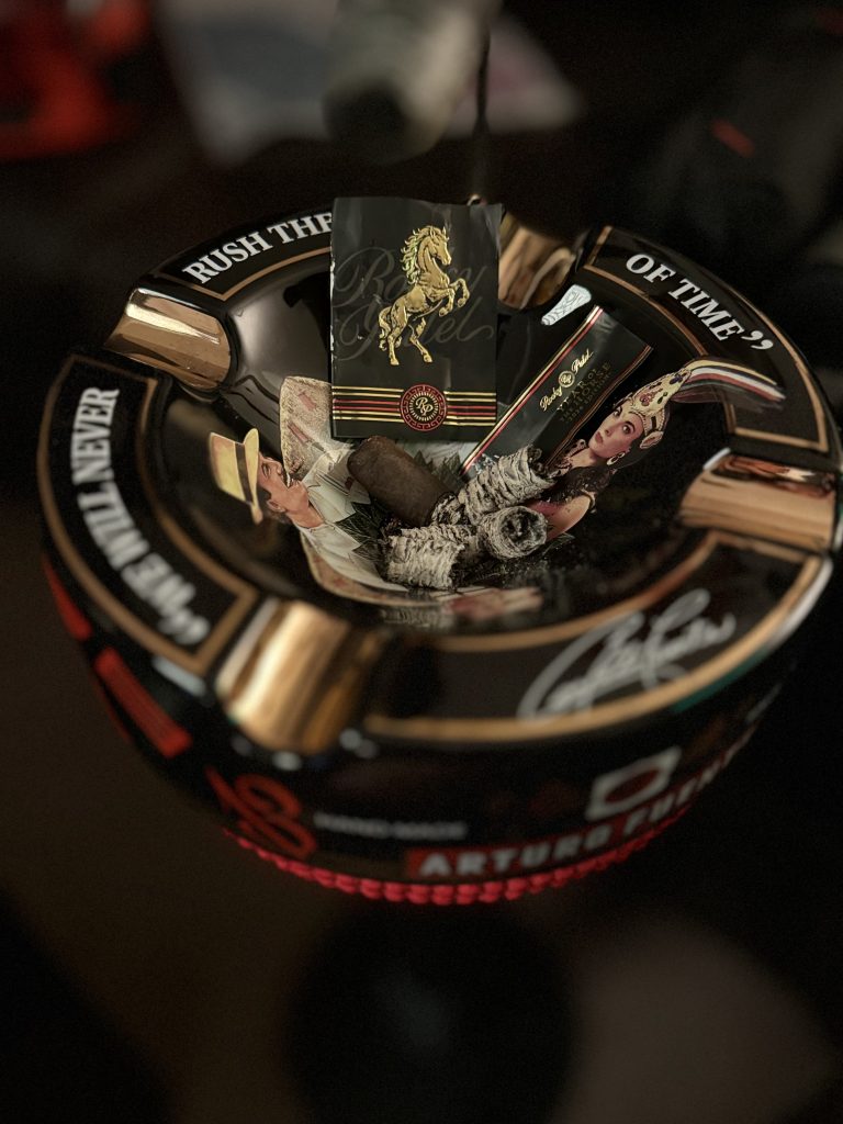 Finished Rocky Patel Year of the Horse cigar with bands and ash in Arturo Fuente ashtray