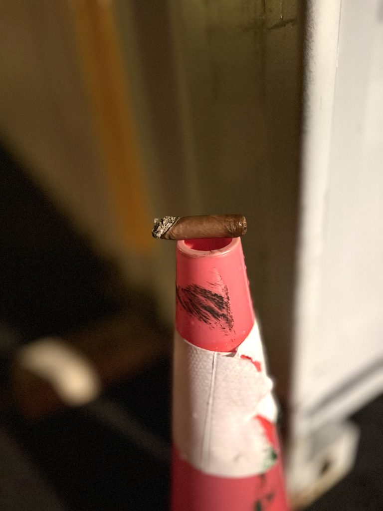 West Tampa Tobacco Company White Toro midway through the cigar with ash and burn line visible.
