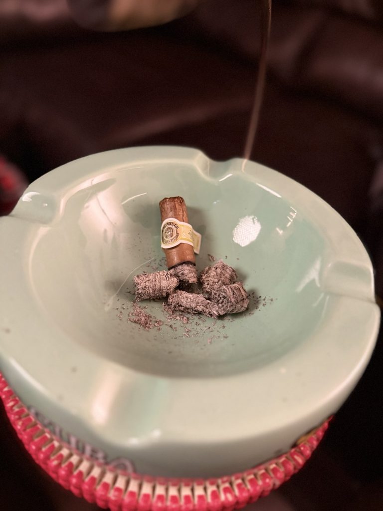 Finished Macanudo Café Prince Philip Churchill nub surrounded by ash inside a green ashtray.