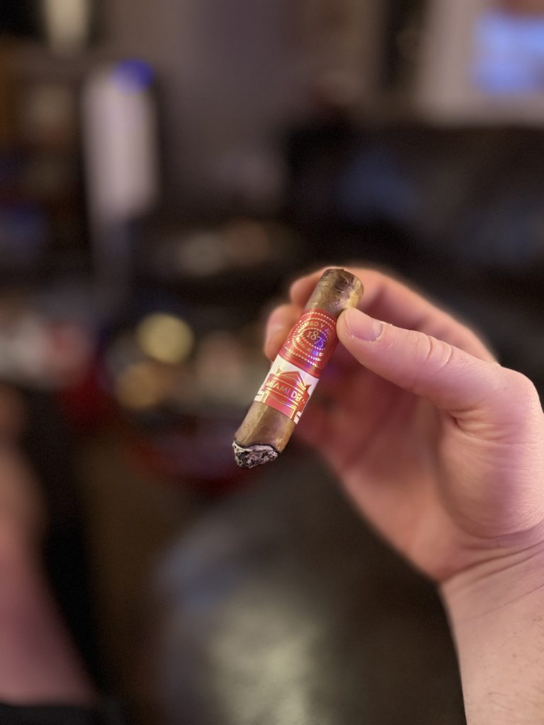 Romeo y Julieta 1875 Miami Deco Toro held at an angle later in the smoking session with the Miami Deco band visible.
