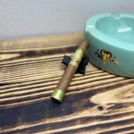 Don Pepin Garcia Vegas Cubanas Toro resting on a black cigar stand beside a green My Father ashtray.