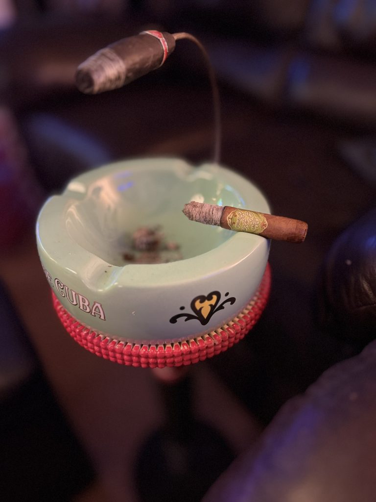 Don Pepin Garcia Vegas Cubanas Toro with a long ash resting on the edge of a green My Father ashtray.