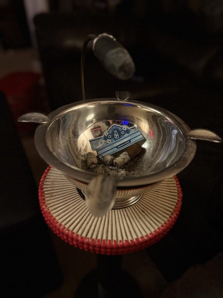 Crowned Heads Moonflower cigar bands and finished nub inside a polished ashtray after the review.