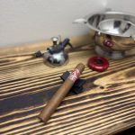 Aladino Cameroon Super Toro resting on a black cigar stand in The Evening Draw Lounge before lighting.