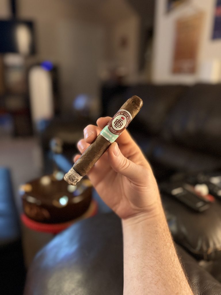Lit League of Fat Bastards Serie O Toro held by hand with a firm ash during the early portion of the smoke.