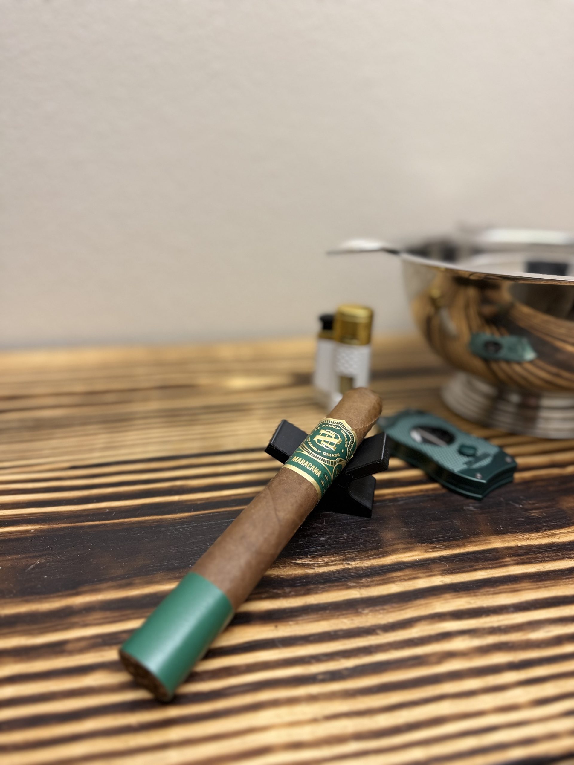 OZ Family Maracana Toro resting on a black cigar stand before lighting