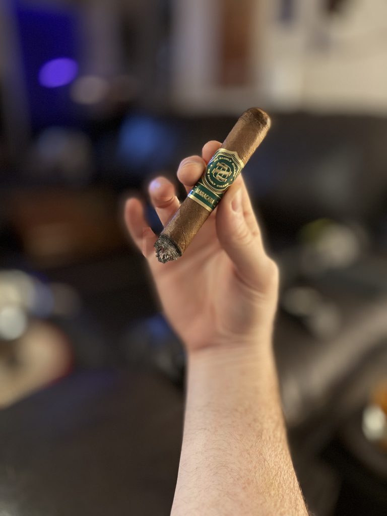Shortened OZ Family Maracana Toro held by hand late in the smoking session