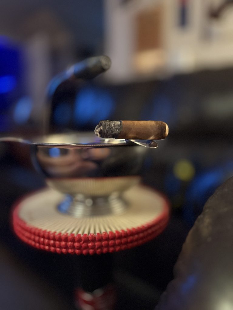 Final portion of the OZ Family Maracana Toro resting on a silver ashtray