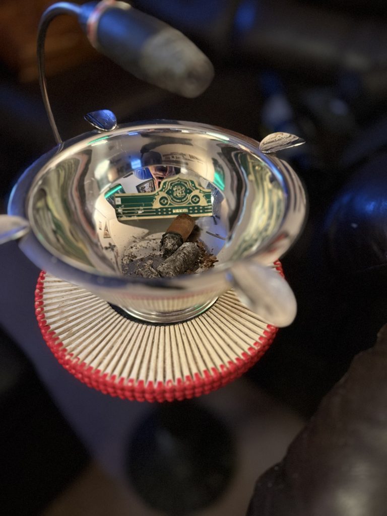 Remains of the OZ Family Maracana Toro inside a polished silver ashtray
