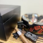 Stolen Throne Call to Arms Sumatra Robusto resting beside a cigar cutter before lighting.
